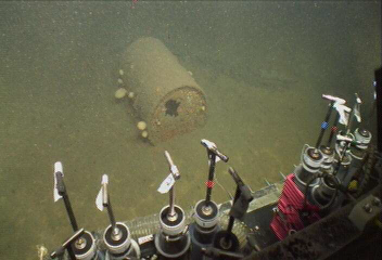 Corroding barrel on the bottom of the ocean floor.